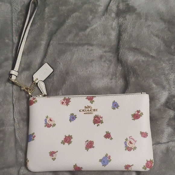 Coach Handbags - Coach White Wristlet with Floral Pattern